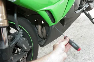 Screws holding lower side fairing
